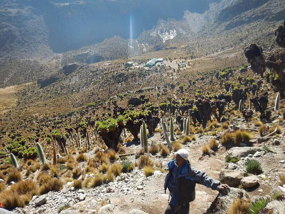 Hikers working their way up a rocky section of Mount Kenya