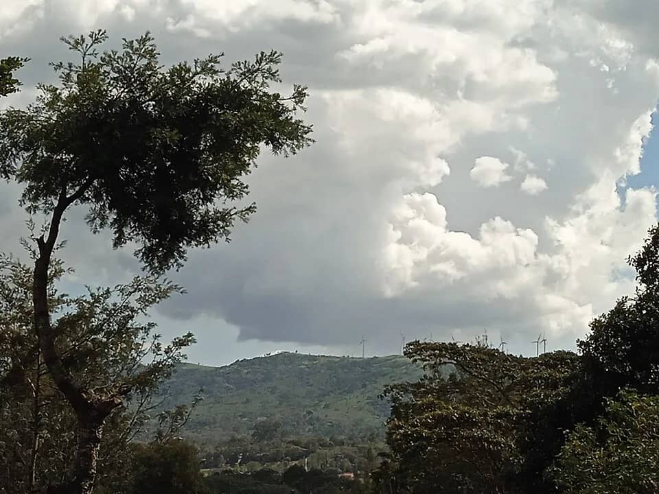 Cloud rolling over the green ridgeline of the Ngong Hills
